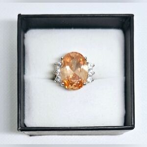 Silver Tone Orange Oval Gemstone Ring with Clear Accent Stones